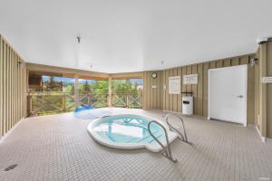 a large room with a large tub in the middle at Central Alpine Condo in Whistler
