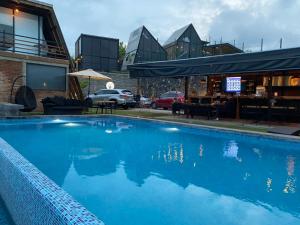a large blue swimming pool next to a building at Macpalo in Amatlán