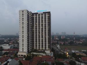 a large white building with a dong sign on it at Dave Apartment in Pondoktjina Tiga