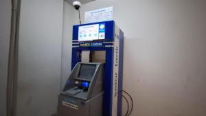 an atm machine with a video game in a room at Dave Apartment in Pondoktjina Tiga