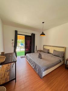 a bedroom with a large bed and a wooden floor at The Up Koh Rong in Kaôh Rŭng (3)