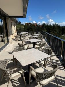 a row of tables and chairs on a balcony at Hotel O2 Tornik in Ribnica