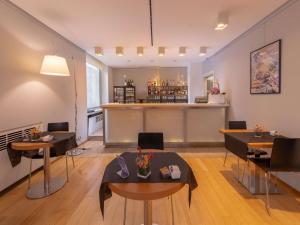a living room with a bar in the background at Hotel Mercure Milano Solari in Milan