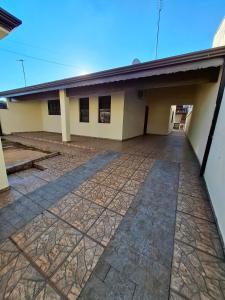 a large building with a large parking lot at Casa c Piscina em Holambra in Holambra