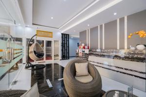 a living room with a chair and a table at RedDoorz Plus near Politeknik Negeri Malang in Malang