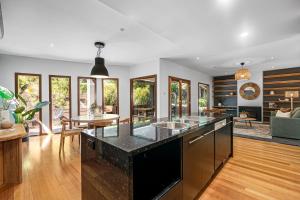 a kitchen with a large island with a black counter top at Guest room in Stirling in Stirling