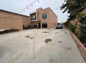 a large parking lot with a car parked in front of a house at CasaLyz in Rosarito Beach