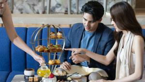 a man and a woman sitting at a table eating food at Centara Grand at CentralWorld in Bangkok +234 photos