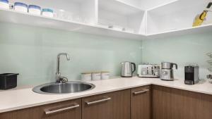 a kitchen with a sink and a counter top at Alkira at The Vintage in Pokolbin