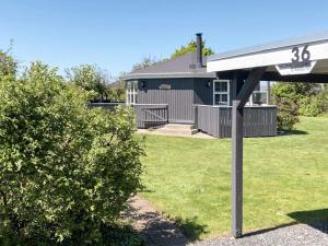 a house with a sign in front of a yard at 4 person holiday home in Vinderup in Vinderup +11 photos