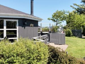 a house with a porch and a yard at 4 person holiday home in Vinderup in Vinderup