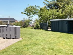 a backyard with a fence and a grass yard at 4 person holiday home in Vinderup in Vinderup