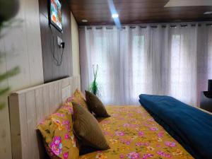 a bedroom with a large bed with pillows at Rautelahomestay in Harsil