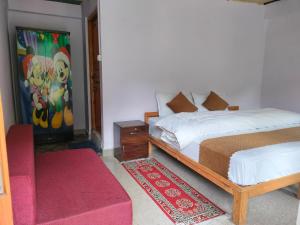 a bedroom with a bed and a red rug at Rautelahomestay in Harsil