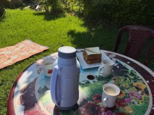 a table with a bottle of water and a piece of cake at Oundo LVHAR in Busia +19 photos