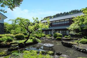 a garden with a stream in front of a building at 一乗谷 朔 saku in Fukui