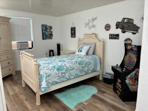 a bedroom with a bed with a blue bedspread at Beautiful Vacation Spot! in Beverly Hills +31 photos