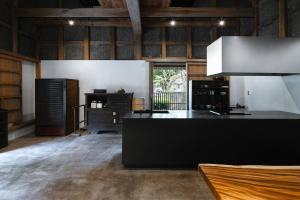 a kitchen with a black island in a room at 一乗谷 朔 saku in Fukui