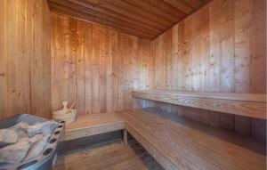 a wooden sauna with a bench and a chair at Strandpark 9 in Schönhagen