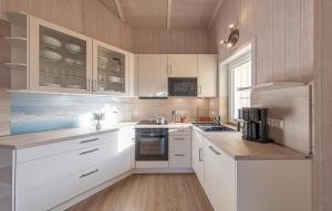 a kitchen with white cabinets and a counter top at Strandpark 9 in Schönhagen
