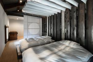 a bedroom with two beds in a room at 一乗谷 朔 saku in Fukui