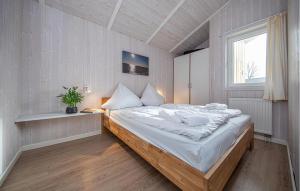 a bedroom with a large bed and a window at Strandpark 9 in Schönhagen