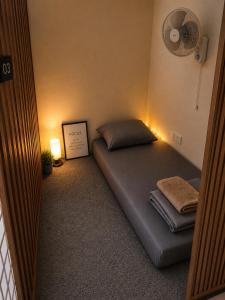 a room with a bed with a fan and lights at The Plywood Pod in Rawalpindi +11 photos
