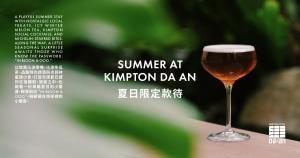 a glass of wine sitting on top of a table at Kimpton Da An Taipei by IHG in Taipei