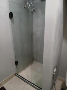 a shower with a glass door in a bathroom at Loft Meu Aconchego in Nova Friburgo +5 photos