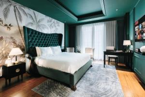 a bedroom with a large bed and a desk at Brilliant Jade Suites in Hanoi