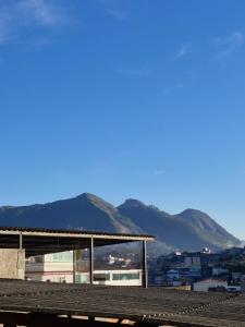 a view of a city with mountains in the background at Loft Meu Aconchego in Nova Friburgo
