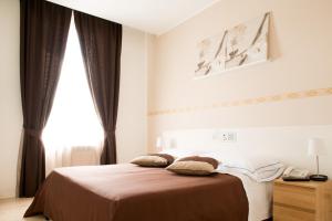 Postel nebo postele na pokoji v ubytování Hotel Indipendenza