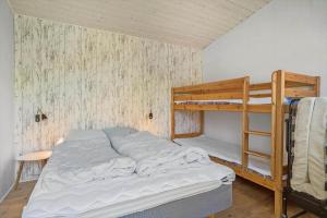 a bedroom with a bunk bed and a ladder at 20103-Samso-Teglvaerksvej-2 in Brundby