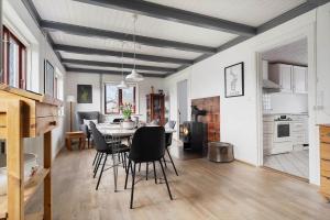 a kitchen and dining room with a table and chairs at 20333-Samso-Havvejen-61 in Sælvig