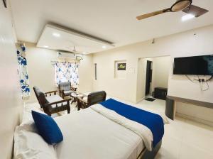 a hotel room with a bed and a tv at Hotel Sri Ram in Similigurha