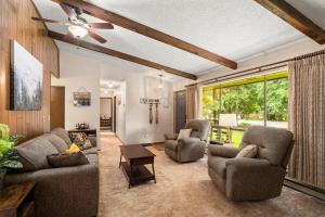 a living room with two couches and a ceiling fan at Cedar Trees Retreat in Sandpoint +13 photos