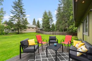 a group of chairs and a table on a patio at Cedar Trees Retreat in Sandpoint