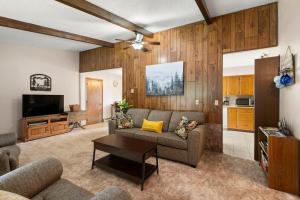 a living room with a couch and a tv at Cedar Trees Retreat in Sandpoint