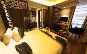 a bedroom with a large bed and a living room at Connaught Royale Delhi in New Delhi
