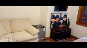 a living room with a couch and a picture at Pousada da Lú in Jaguarão