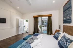a bedroom with two beds and a television at Reflections Turquoise Villa 4 in Picnic Bay