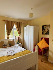 a bedroom with a bed with a white refrigerator at Erris house in Belmullet