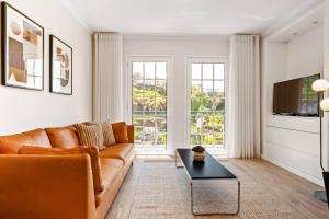 a living room with a couch and a table at Sunlit Apartment with Balcony & Atlantic Views in Ponta do Sol