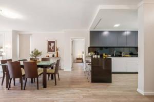 a kitchen and dining room with a table and chairs at Sunlit Apartment with Balcony & Atlantic Views in Ponta do Sol