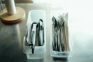a plastic container filled with cutlery on a table at Kumano Base in Tanabe
