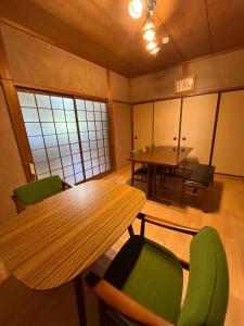 a room with a table and chairs and a table and a tablektop at Kumano Base in Tanabe