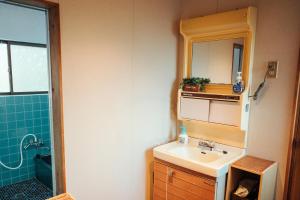 a bathroom with a sink and a mirror at Kumano Base in Tanabe +36 photos