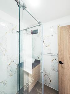 a shower with a glass door in a bathroom at Colseguros in Cali +119 photos
