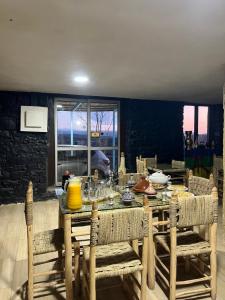 a dining room with a table and chairs at Gîte Touften in Aït Aïouz