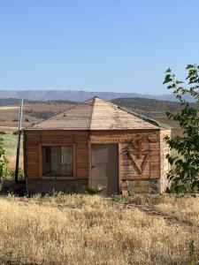 a small building in a field of grass at Gîte Touften in Aït Aïouz